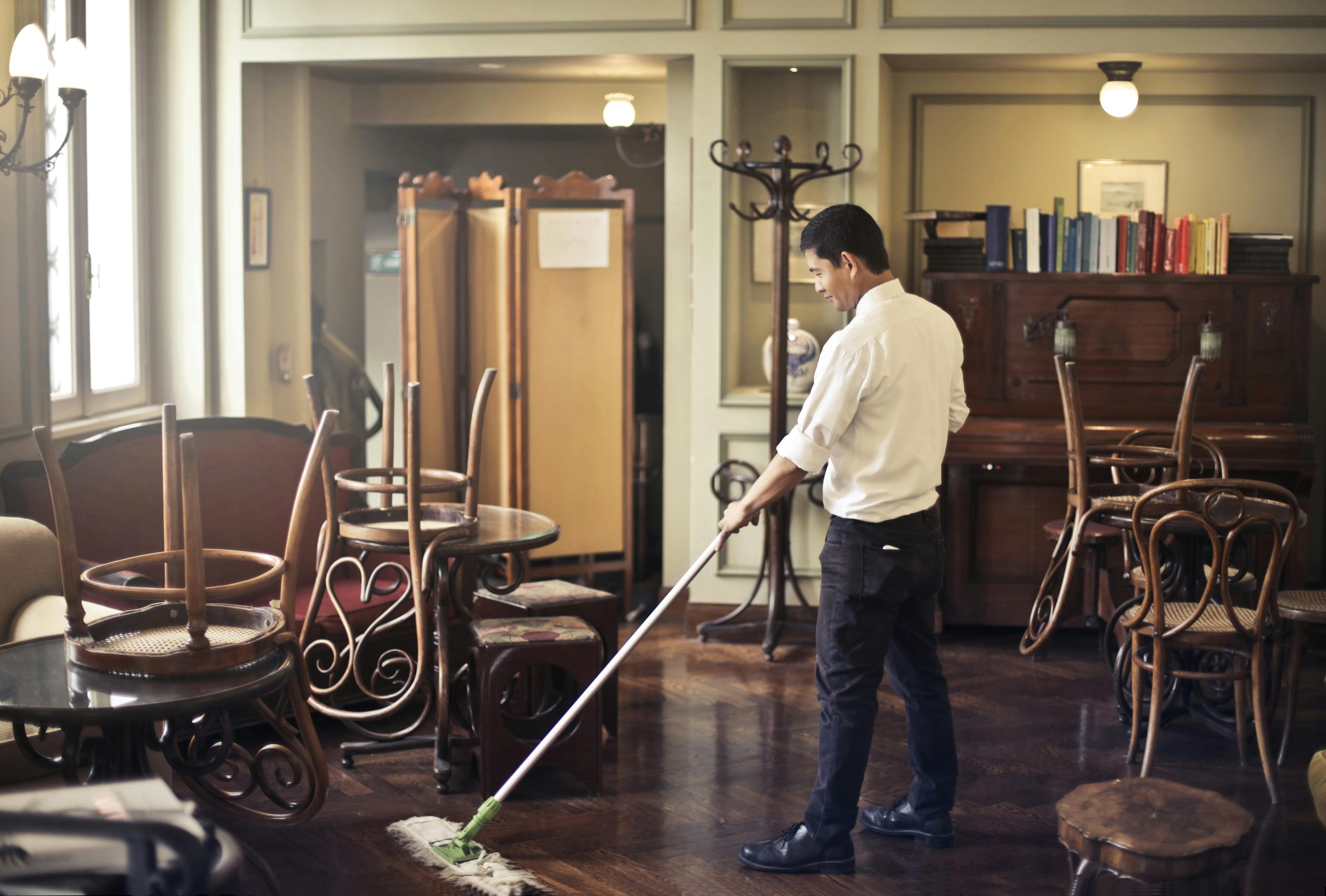 Illustration, apartment maintenance. A man washes the floor